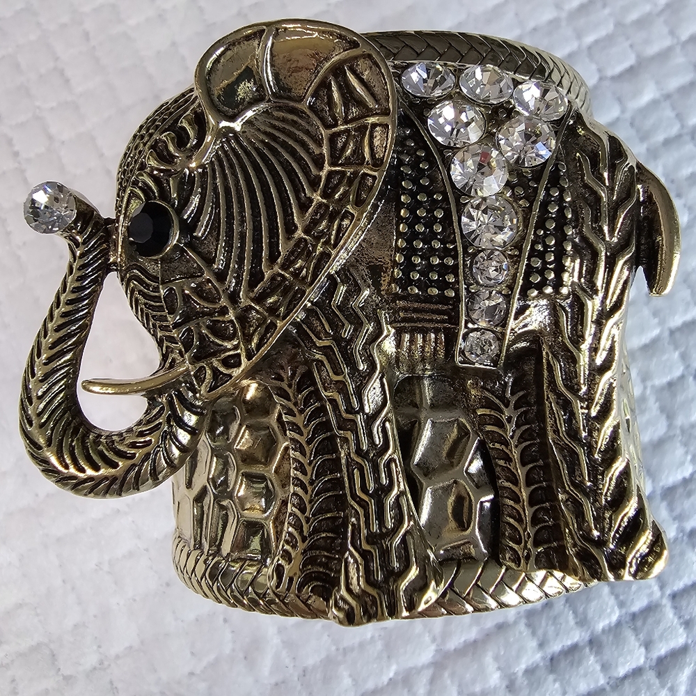 Gold tone elephant cuff bracelet with Rhinestone detail.